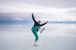 © Alexandre - Sun Burnt Caucasian Bold Man with Sunglasses in Black Shirt and Green Pants Poses in Flooded Uyuni Salt Flats at Sunset