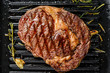 Grilled rib eye, ribeye  steak in a pan. gray background. top view