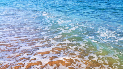 Wall Mural - Sea water with white foam in the coastal sand