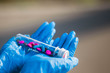 © Alex - Protection. Tablets. Vaccine. Coronavirus. Hand in gloves holding pills. Vitamins. Salvation. Age. The glove.