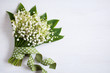 A bouquet of lily of the valley on a wooden background