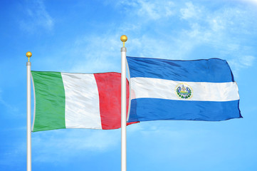 Italy and El Salvador two flags on flagpoles and blue cloudy sky