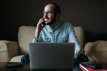 Man calling and working from home while is looking thought the window