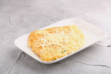 omelet with parmesan and basil. breakfast concepy closeup. on light background