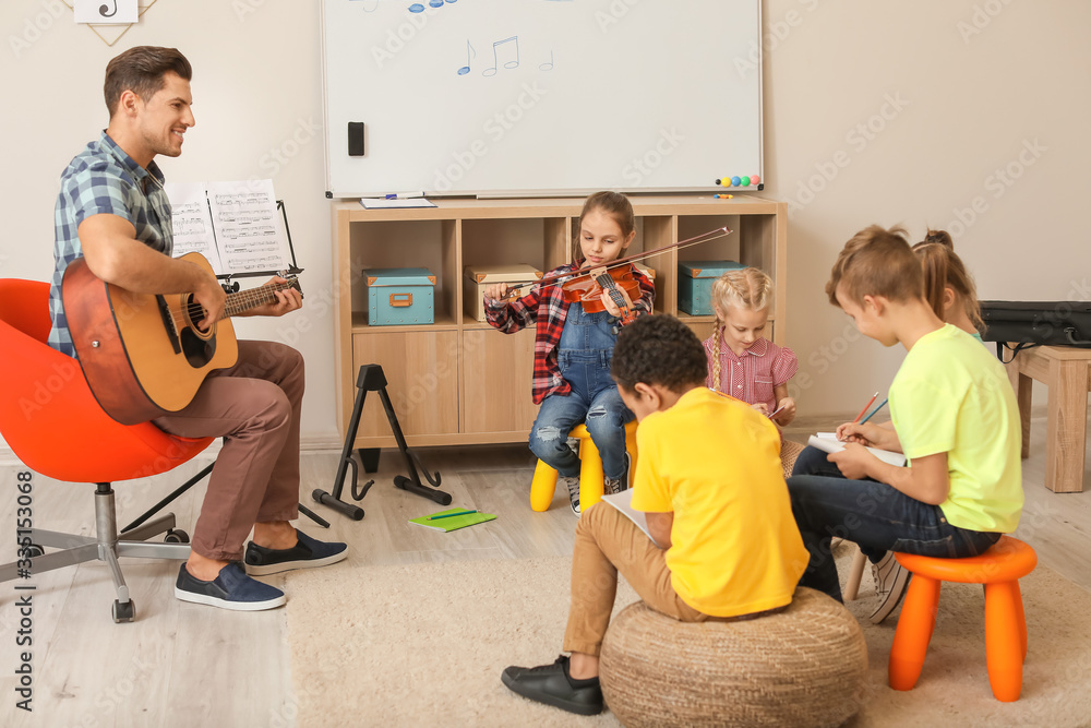 Teacher giving music lessons at school