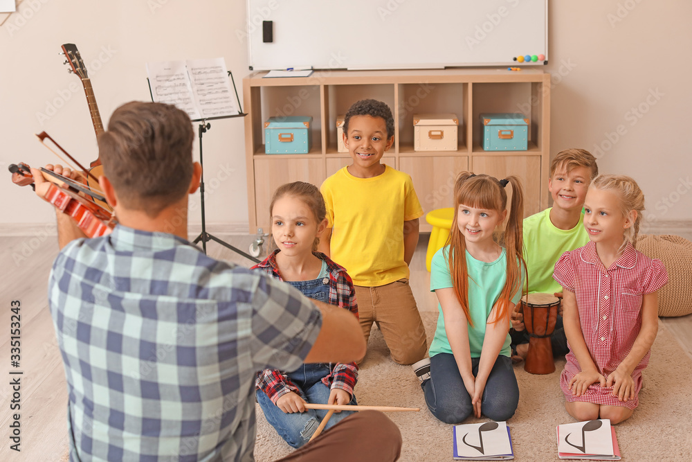 Teacher giving music lessons at school