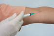 © Amauta Fotografia - Doctor using a syringe in a patient's arm