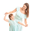 © Pixel-Shot - Happy mother and her little daughter dancing against white background