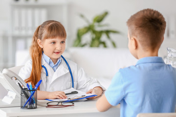 Sticker - Cute little doctor working with patient in clinic