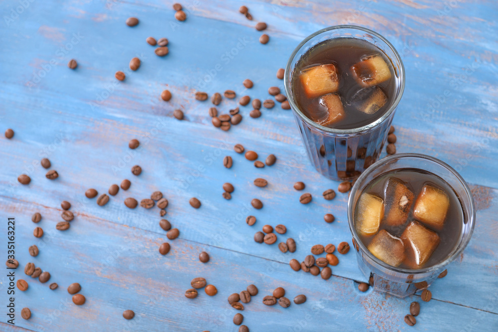 Glasses of tasty iced coffee on table