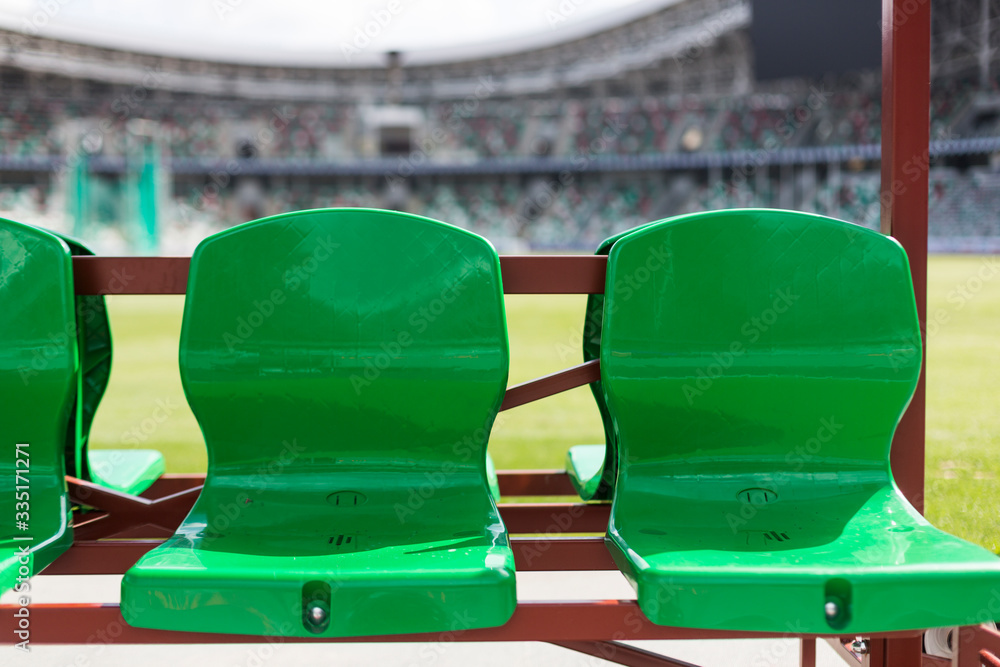 Coach and staff bench, green plastic seats at football stadium Stock ...