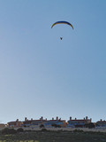 Fototapeta Lawenda - Paraglider flying in blue sky.