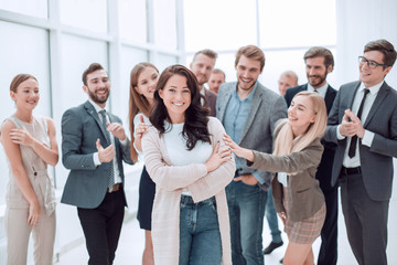 happy business team applauding their young leader.