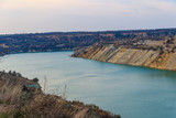 Fototapeta Mapy - View of a lake with sandy shores in flooded sand quarry