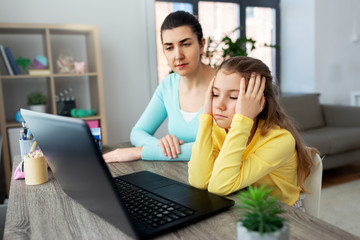 Sticker - education, family and distant learning concept - mother and bored daughter with laptop computer doing homework together at home