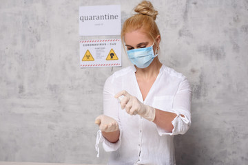 Woman in quarantine for Coronavirus wearing protective mask and gloves.