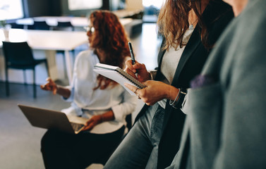 Woman making notes during a meeting