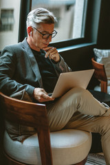 Businessman looking busy working on laptop