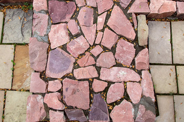 Wall Mural - cobblestone pavement made of red rough stone, texture top view.