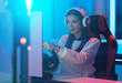 © Artem - The beautiful gamer girl with headphones playing video games