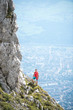 © Leonid - Man standing on the edge of the rock