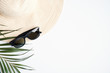 © photoguns - Straw hat and sunglasses with tropical palm leaf on white background. Travel or summer holiday vacation concept. Flat lay, top view, copy space