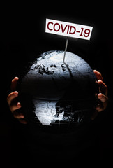 Wall Mural - hands of kid holding globe covid-19 pandemic infection disease concept