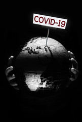 Wall Mural - hands of kid holding globe covid-19 pandemic infection disease concept