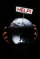 Wall Mural - hands of child holding globe. our planet need help sign