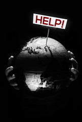 Wall Mural - hands of child holding globe. our planet need help sign