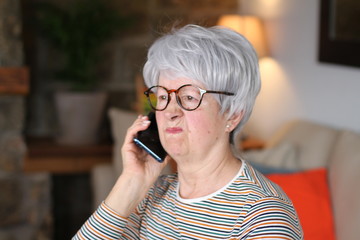 angry senior woman on the phone