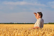 © Ryzhkov Oleksandr - Satisfied mature farmer touching with care his ripe wheat field