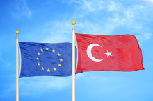 European Union And Turkey Two Flags On Flagpoles And Blue Cloudy Sky