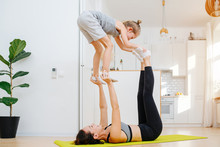 Mom And Son Doing Gymnastic Acrobatic Form At Home