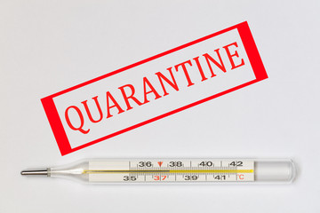 Red Quarantine sign on mercury thermometer on white background