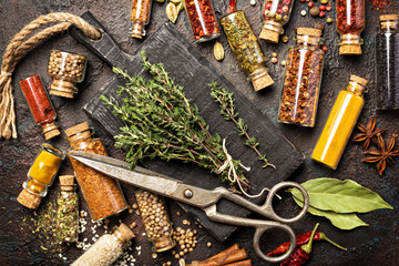 Wall Mural - Different spices, dry kitchen herbs and seeds in glass vials for tasty meals