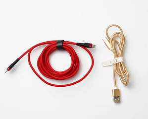 twisted cable for charging mobile devices in a red and golden textile wrapper