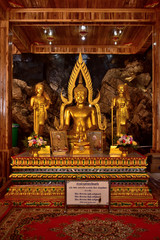 Golden statue of buddha in temple, Thailand	