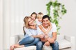 © BillionPhotos.com - Beautiful smiling lovely family sitting on sofa