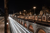 Fototapeta Uliczki - Street with cars lights through the city at night