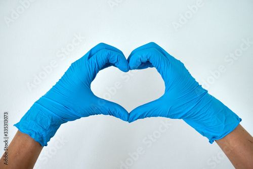 Human rising hands make finger heart shape wearing blue disposable latex glove, Tableau sur Toile