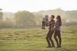 © hetmanstock2 - Family with cute little son. Father in a red shirt. People walking near horses.
