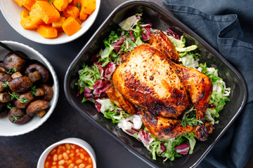 Canvas Print - Table with whole roasted chicken, salad, pumpkin, mushrooms, beans