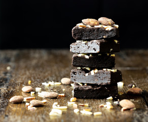 Black brownie almonds on wood table, close up picture.