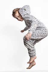 Wall Mural - Happy and cheerful boy jumping in various poses on a white background. The movement of life of free children