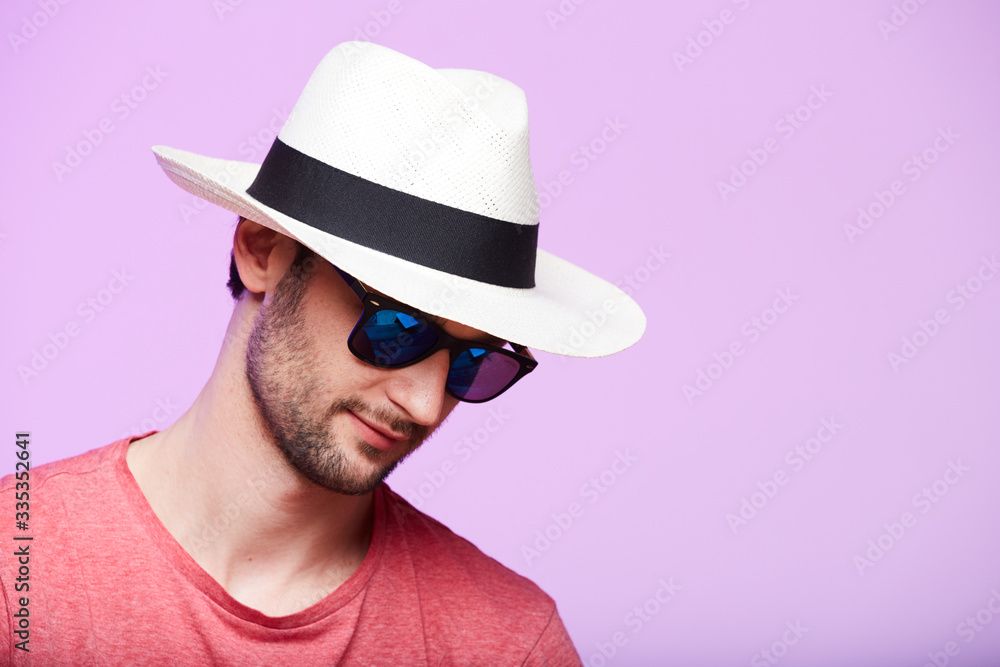 Closeup portrait of awesome hipster wearing fedora hat with intense look at camera. Headshot over pink studio background. - obrazy, fototapety, plakaty 