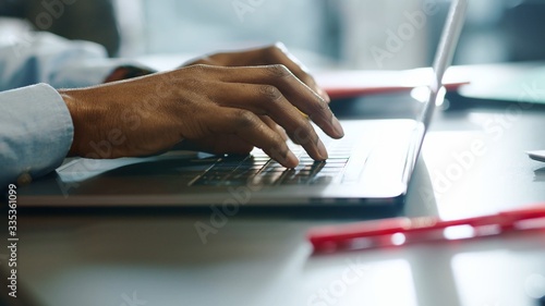 Cuadros en Lienzo Close up hands man african american young uses laptop typing touch work in offic