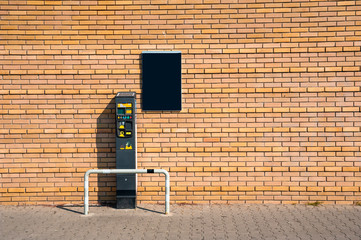 Closeup of parking meter and brick wall