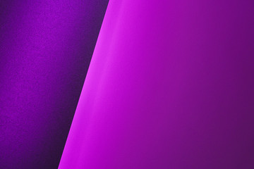 Wall Mural - Blank paper sheets rolled in a neon purple lighting close up