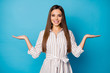 © deagreez - Photo of pretty attractive manager lady good mood hold two open arms empty space showing sale price products offer pick best wear striped dress isolated blue color background